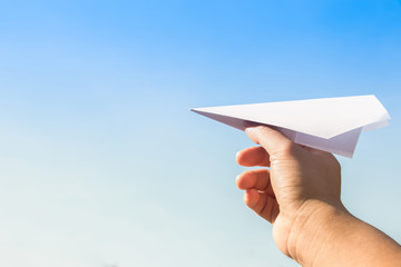 Hand holding rocket paper with blue sky. concept freedom
