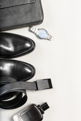 shoes and accessories for men lay on the wooden floor