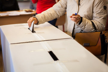 A person casts her ballot during voting for parliamentary elections at a polling station in Bucharest, Romania.