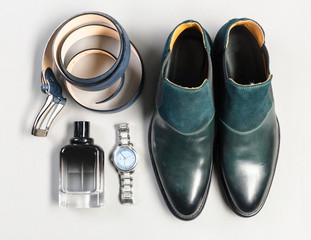 shoes and accessories for men lay on the wooden floor