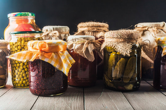 Preserved vegetables on wooden background