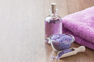 Obraz na płótnie Canvas SPA treatment set / Sea salt, aromatic essential oil, soft towel for massage on wooden background