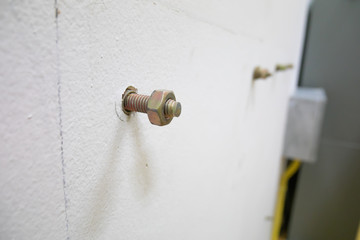 Close up , bolt and nut on wall.