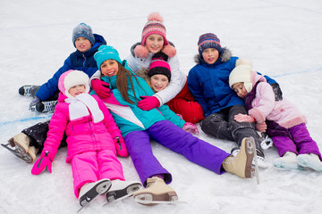 group of kids lying on the ice