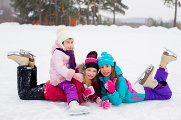 group of kids lying on the ice