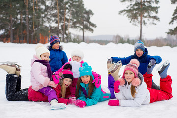 group of kids lying on the ice