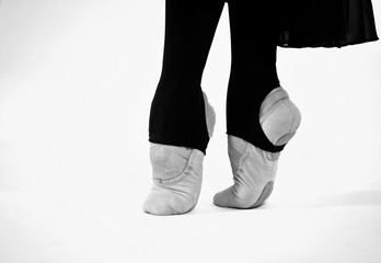 black and white photo of ballet dancer feet on a white background