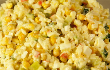 Salad with crab sticks, corn, cucumber, eggs and rice