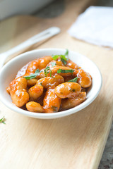 serving of large fava beans cooked in red sauce