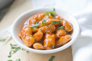 serving of large fava beans cooked in red sauce
