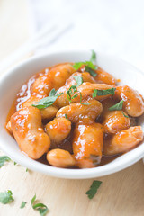 serving of large fava beans cooked in red sauce