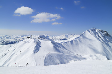 Ski slopes, chairlift on top of a mountain in French Alps on a clear winter day, Paradiski, Plagne,