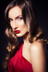 Naklejka premium Brunette beautiful luxury woman in red dress with clear skin and