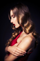 Naklejka premium Brunette beautiful luxury woman in red dress with clear skin and