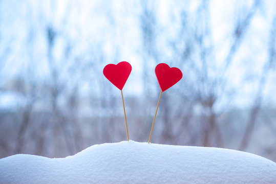 two beautiful hearts on a winter background
