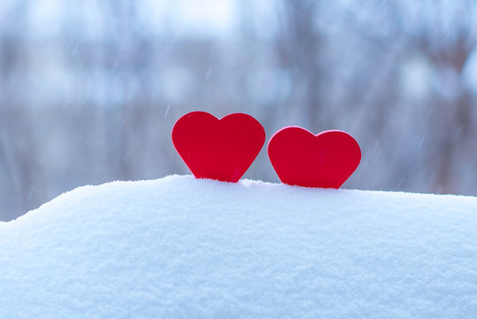 two beautiful hearts on a winter background