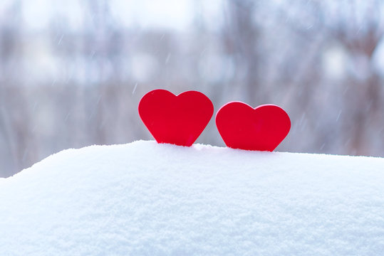 two beautiful hearts on a winter background