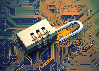 Computer security concept. Padlock on computer circuit board