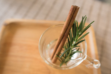 rosemay and cinnamon in glass