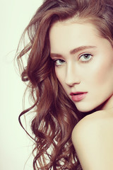 Fototapeta premium Vintage style portrait of young beautiful girl with long healthy curly hair