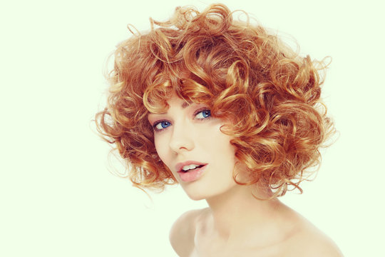 Vintage style portrait of young beautiful happy healthy woman with curly red hair 