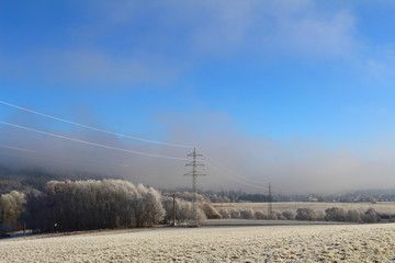 clouds over the frozen field und blue sky