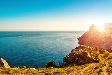 Awesome landscape of seashore and mountain on the blue sky background. Sunset