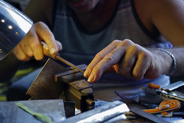 Hands Filing a Metal Molder Blade