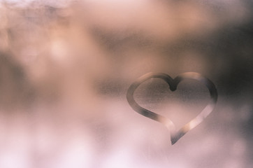 Fototapeta premium Heart painted on glass in foggy weather