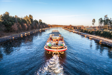 inland vessel drives a canal river along - obrazy, fototapety, plakaty
