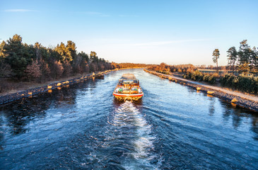 inland vessel drives a canal river along