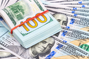 Pile of one hundred american dollar bills close up