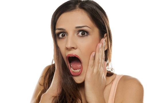 shocked young woman on white background