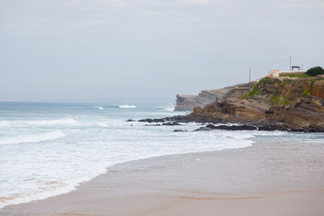 atlantic coastline with surfes in cloudy day