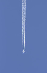Avi&oacute;n dejando una estela en el cielo azul