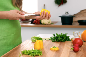 Close up of  woman's hands cooking in the kitchen. Housewife slicing ​​fresh salad. Vegetarian and healthily cooking concept
