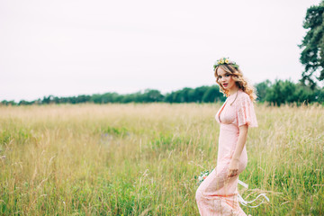 Fototapeta na wymiar Young Woman In Boho Dress Standing On Meadow