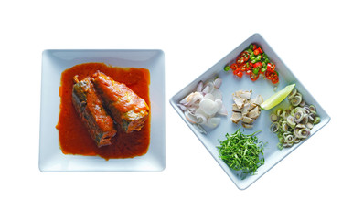 MACKEREL FISH IN TOMATO SAUCE ON THE WHITE CERAMIC DISH