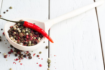 a mixture of peppers and chili pod on a light background