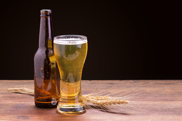 cup of beer on wooden table.