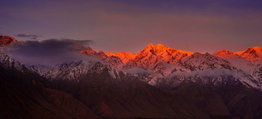 beautifull cloudy sunrise in the mountains with snow ridge