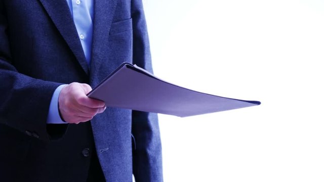 Businessman hands over a folder with papers