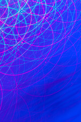  Abstract moving light patterns swilring light streams from long exosure against blue hue background