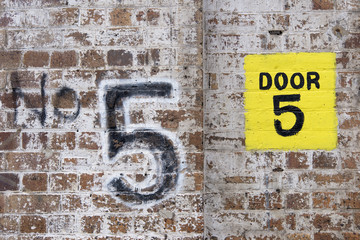 Number Five Yellow Painted Square brickwall.