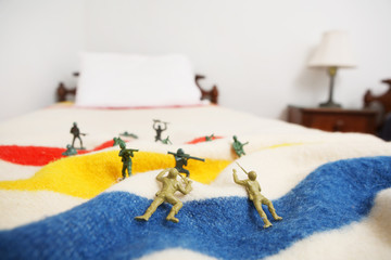 Toy soldiers on a bed