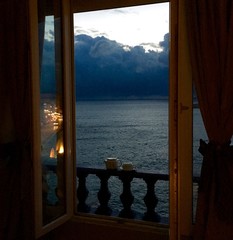 A perfect cup of tea: as the storm clouds gather at dusk over the bay of Marseilles, France, the homeward bound traffic on the Corniche is reflected in the open window.  Exquisite tranquillity