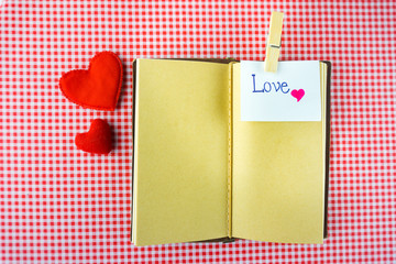 Valentines notebook with message card on red background Image of