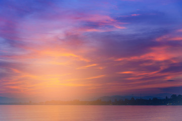 Naklejka na ściany i meble Dramatic sunset sky with clouds over sea.