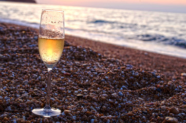 Wineglass on the beach in the evening