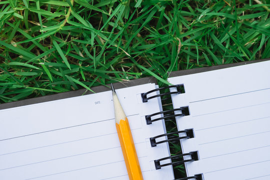 To do list notebook in green grass - Powered by Adobe